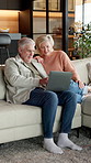 Mature, couple and laptop on home sofa for online browsing, social media and internet connection. Happy man, woman and smile with technology to search, talking or streaming on living room couch
