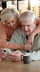 Hug, phone and senior couple in dining room of home for connection, reading or text message. App, social media and typing with old people in apartment together for communication or internet search