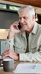 Laptop, laughing and phone call with old man at desk in home for finance or retirement planning. Budget, communication and financial documents with funny senior person in apartment for accounting