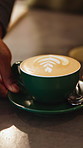 Serving, coffee shop and hands of woman with cappuccino, drink and beverage for takeaway. Restaurant, counter and waitress with latte, caffeine and customer order for service, help and hospitality
