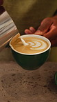 Pattern, milk and hands of person in coffee shop, restaurant and prepare for customer order. Barista, hospitality and worker pour caffeine drink for espresso, cappuccino and latte art in cafeteria