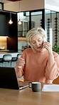 Documents, finance and phone call with old woman at desk in home for budget or retirement planning. Accounting, computer and financial papers with senior person in apartment for feedback or review