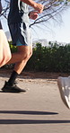 Fitness, legs and running with people outdoor on road together for marathon or training. Cardio, exercise and sports activity with runner group on path in nature for action, pace or workout routine