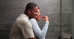 Love, happy couple and brushing teeth with hug in bathroom, dental wellness or oral hygiene. African man, woman and toothbrush at home for gum care, embrace and smile with partner in morning routine