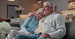 Senior, couple and watching tv in living room with hug, smile and bonding together for retirement. Married, elderly people and relax in house with embrace, streaming film and discussion for movie.