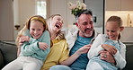 Happy family, kids and tickle with parents in home, laugh and bonding together in living room. Sisters, mother and father with girls for funny game, love or playing for connection on weekend