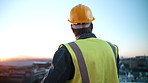 Back, thinking and engineer in city for construction, inspection and planning for architecture. Space, man and hardhat outdoor with reflection, urban view and quality assurance for building project