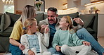 Love, parents and kids laughing in family home with conversation, happiness and connection together. Talk, mother and father with children on floor in lounge, bonding and pointing with funny sisters