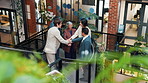 Team, lobby and business people with hand stack, applause and success for remodeling contract. Green office, stairs and workers with meeting, achievement and celebrate news at interior design agency