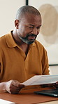 Laptop, document and black man in home with remote work, administration or research for tax preparation. Freelancer, mature person and computer in house with paperwork, review and wealth management.
