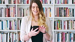 Teacher, typing and happy woman with phone in library for academic study, knowledge or information. Female person, professor or scrolling with smile on smartphone for online curriculum or syllabus