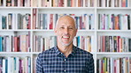 Publishing, laugh and face of man with books for career, opportunity and about us at agency. Creative, bookshelf and portrait of mature person for publicist, managing editor and publication house