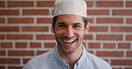 Education, face and laughing with Muslim man on brick wall background at college campus. Belief, faith and learning with funny student at university for Arabic, Islamic or religious studies as pupil