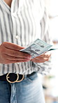 Shopping, hands and cashier with cash count in store for transaction, confirm amount or security. Commerce, customer and person with dollar bills for purchase sale, checkout and verify money in shop