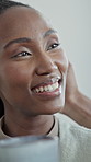 Happy, black woman and relax in home with coffee, start day and calm morning in living room. Female person, couple and laugh at house with beverage, funny discussion and comfortable for weekend break