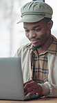 Man, typing and remote work in diner with laptop, creative project and editing article for blog post. Freelance, writer or black person in cafe with computer, online research or planning for campaign