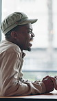 Love, holding hands and black couple in cafe, laugh and romantic connection with happy partner. Coffee shop, man and woman with affection on date, funny joke or healthy relationship for support