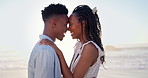 Smile, travel and couple at beach with love, affection and bonding on tropical holiday. Happy, admiration and black people at ocean with flare, commitment and healthy relationship on getaway vacation