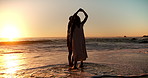 Beach, dance and couple in ocean with sunset for bonding on vacation, holiday and travel together. Dating, sea and man with woman with spin for relationship, connection and romantic moment for love