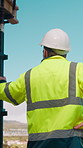 Back, man and construction worker by scaffolding with city view, thinking and property development. Engineer, person and reflection outdoor on site with PPE, building framework or vision for project.