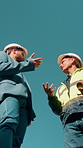 Construction, team and men planning with low angle, building development or project review. Engineer, discussion and outdoor for solution, architecture strategy and collaboration on site with space
