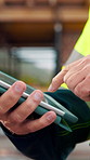 Contractor, construction site and hands with tablet, typing or urban planning for quality control. Inspection, digital tech and man with project management for civil engineering or development