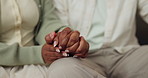 Couple, holding hands and loyalty in lounge, home and bonding with partner on weekend or connection. People, love and commitment for relationship, support and solidarity with spouse in living room