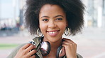 Face, headphones and black woman in city, funny and confidence with fashion, trendy and laugh. Outdoor, African person and listening to music, sound and digital app for audio, radio and technology