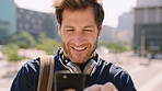 Man, phone and texting in city for travel with smile, music and bag for international tourism. Mature person, sound and happy with social media, mobile app or contact on web for trip in urban town