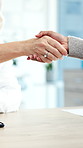 Handshake, greeting and doctor with patient in hospital for agreement in medical consultation. Appointment, welcome and healthcare worker shaking hands with person for thank you at checkup in clinic.