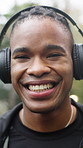 Exercise, face and black man with headphones in rain for fitness dedication, morning cardio or laugh. Rest, runner and happy outdoor for winter wellness, health discipline or streaming music playlist