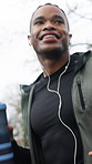 Workout, man or running with earphones at park for exercise, pace training or music playlist. Water bottle, happy black person and cardio with audio streaming, jogging routine and physical activity