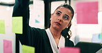 Woman, glass wall and sticky note with tablet in office for insight, writing and review at finance agency. Person, broker and planning with tech, application or solution at asset management company