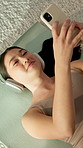 Relax, headphones or asian woman with phone for fitness, audio therapy or mindfulness above in home. Top view, female person or lying with smartphone, sound app or podcast for calm music in house
