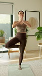 Meditation, namaste and asian woman with balance in home for mindfulness or spiritual wellness. Calm, female person or hands together with zen or pose on mat for fitness, health or wellness in house