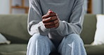 Hands, nervous and person in therapy with anxiety, anticipation or habit for coping mechanism. Patient, fidget or restless on sofa with stimming, trauma response and overwhelmed for emotional tension