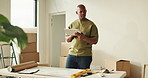 Tablet, planning and black man in new home with moving for online shopping, decision or furniture order. Digital tech, problem solving and person with choice for living room renovation and thinking