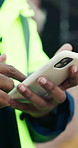 Phone, man and hands on construction site with developer for building, renovation project or repairs. Safety, feedback and civil engineer with digital tech for inspection update or risk assessment