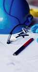 Hard hat, construction and blueprint on table with safety documents, architecture or building design. Floor plan, paperwork and helmet for ppe, equipment and tools for infrastructure development