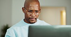 Black man, laptop and thinking in lounge with remote work, review and report for project management. Person, freelance writer and computer with reflection or editing for creative proposal in home