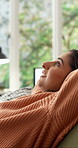 Woman, relax and stretching on sofa with smile, comfort and stress relief on weekend in home. Peace, female person or satisfaction in living room for day off, daydreaming and resting for self care