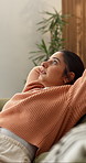 Woman, relax and stretching on sofa with breathe, comfort and stress relief on weekend in home. Peace, female person or satisfaction in living room for day off, daydreaming and resting for self care