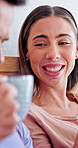 Couple, laugh and drinking coffee in bed with conversation, bonding together or funny story on weekend. Happy, people dating and relax in home with warm tea, humor and talk for connection in morning.