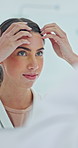 Mirror, hair care and woman in bathroom for beauty, grooming and preparation with morning routine. Reflection, hairstyle and person at home to check growth, smile and getting ready to start day