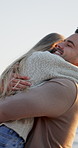 Excited, travel and couple with hug on beach for romance, date and anniversary vacation or bonding together. Sunset, love and playful people with kiss for weekend holiday, loyalty and support