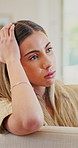 Annoyed, unhappy and woman in home with conflict, argument or breakup for problem in relationship. Angry, upset and female person in bad mood for fighting with divorce in living room at house.