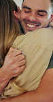 Hug, keys and couple in new house on date with bonding, support or comfort with property investment. Happy, marriage and man embracing woman for celebration of real estate together in apartment.