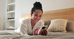 Woman, relax and typing in hotel room with phone, text message and social media update on vacation. Happy, person chill and browsing on bed with tech, holiday and website booking for accommodation.