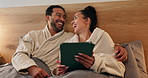 Couple, laugh and relax in hotel room with tablet, social media meme and romantic vacation at night. Late, happy married people and rest in accommodation bed with tech, joke and bonding on holiday.
