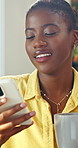 Woman, relax and coffee in home with phone, social media and text message in lounge. Smile, beverage and African person at house with mobile app, browsing website and notification for chat response